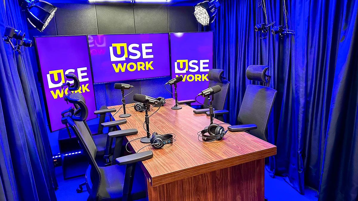 Professional dark podcast studio with microphones and neon lights
