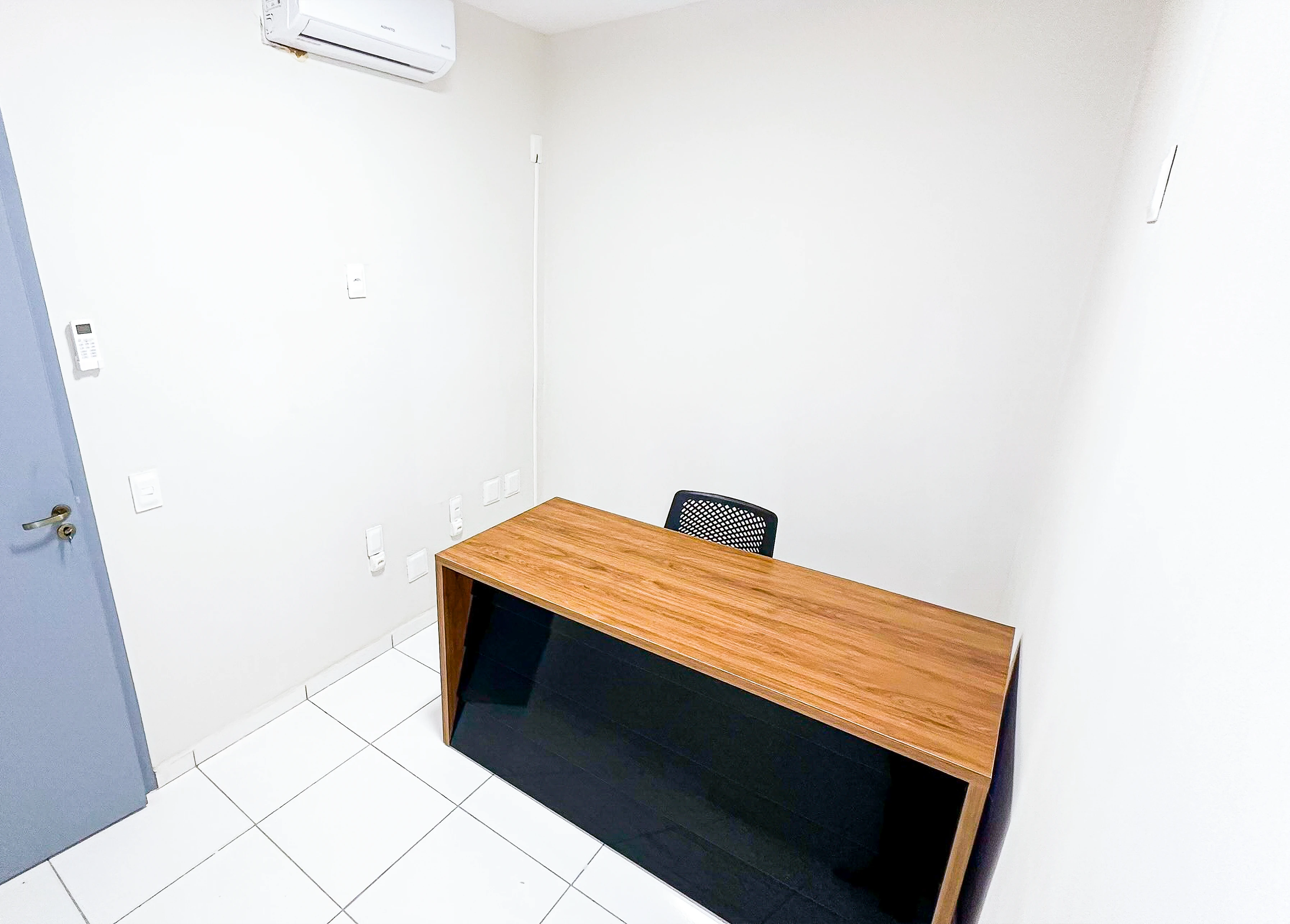 Medium sized office with glass walls and two desks